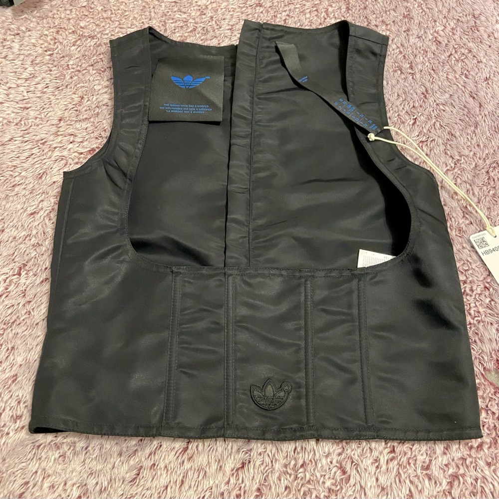 Black adidas corset . Zipper down the back.NWT